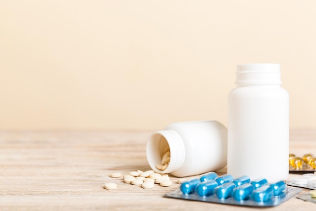 Medicine for treatment HIV infection Pills and capsules and battle on the table Different colorful tablets at colored background with copy space