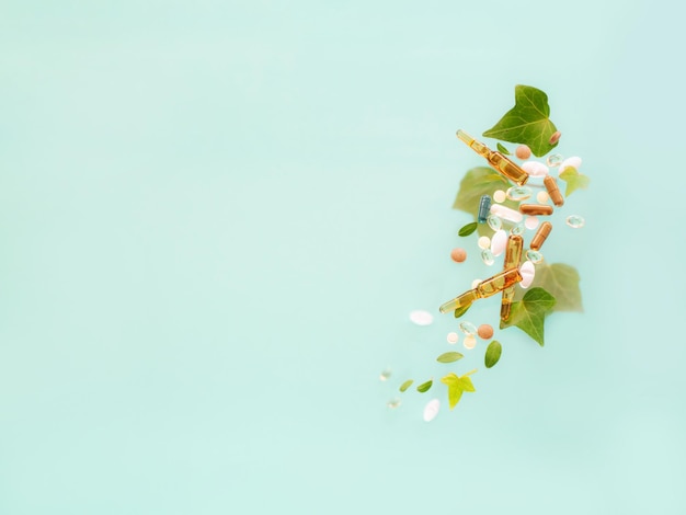 medicines made from natural ingredients with leaves on green background