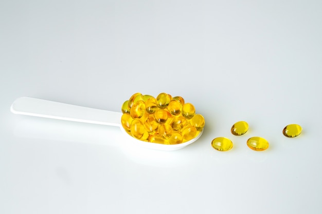 Medicines and treatment, healthcare. Vitamin pills in the spoon.