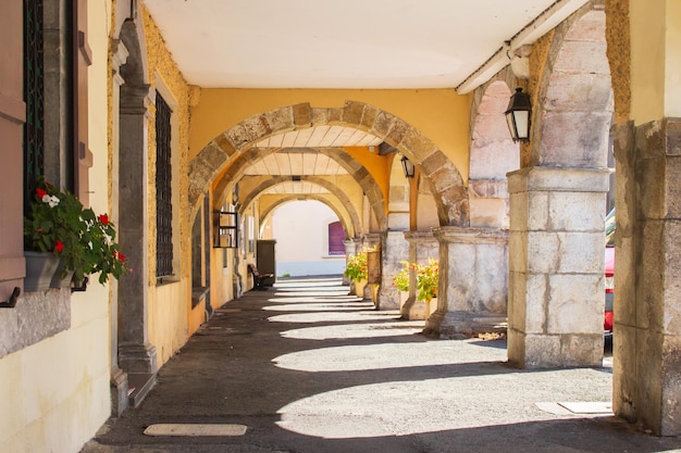 Medieval backyard with arch and flowers. Ancient architecture in France. French rural building.