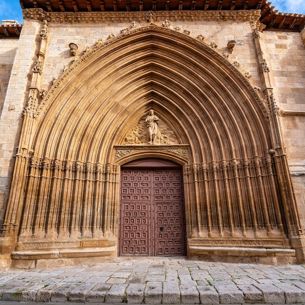 Medieval church facade highly decorated with stone carvings in Aranda de Duero Burgos