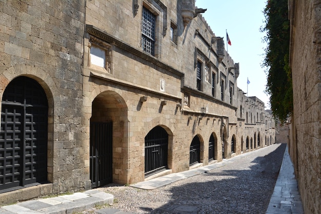 medieval street of knights with pebbled walkway, arched doors and brick walls, no people