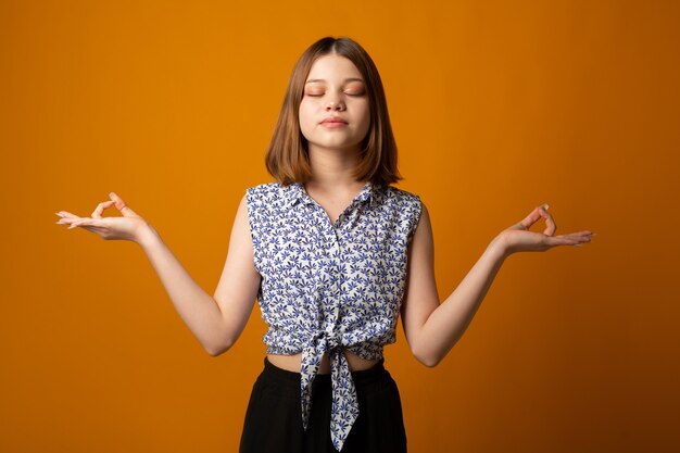 meditating beautiful young female in yoga pose