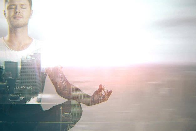 Meditating businessman on city background