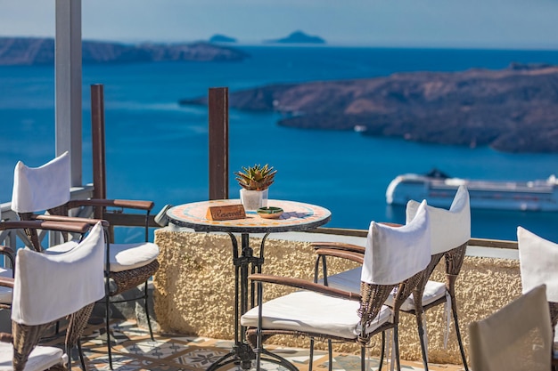 Mediterranean Cafe on terrace with beautiful sea view. White architecture, Santorini island, Greece