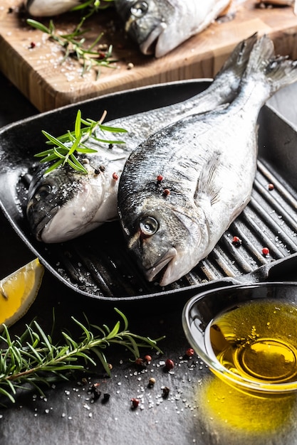 Mediterranean fish bream with spices salt herbs garlic and lemon. Healthy seafood. Concept of healthy sea food.