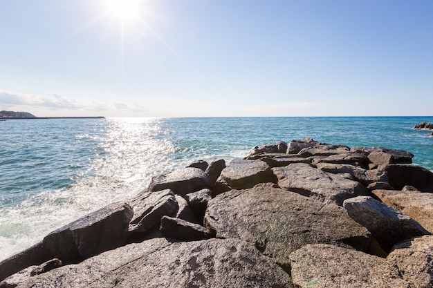 Mediterranean seascape, blue sea, rocks on the coast, summer day