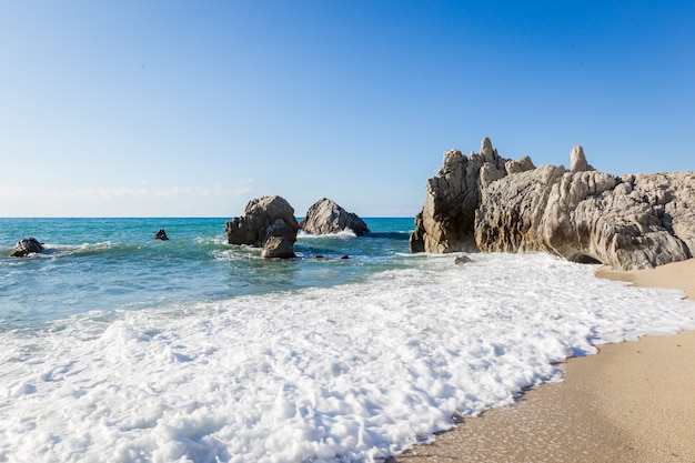 Mediterranean seascape, blue sea, rocks on the coast, summer day