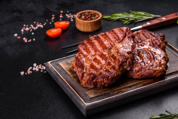 Medium rare sliced grilled striploin beef steak served on wooden board