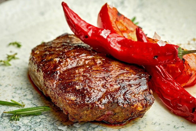 Medium rare steak on a white plate with spices Closeup selective focus