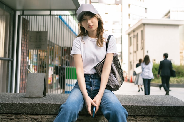 Medium shot asian woman wearing trucker hat