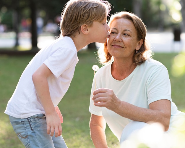 Medium shot boy kissing grandma