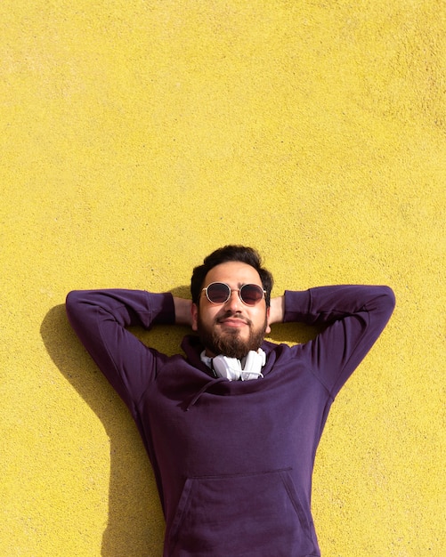 Medium shot boy laying with sunglasses