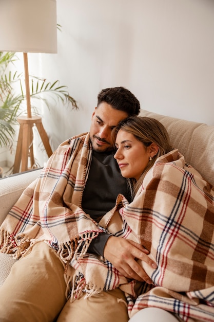 Medium shot couple being affectionate indoors