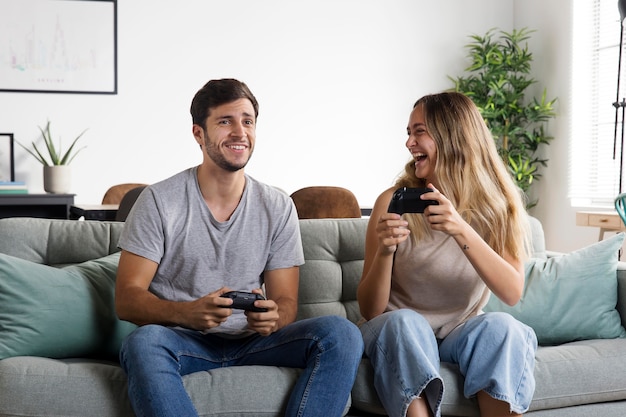 Medium shot couple playing games at home