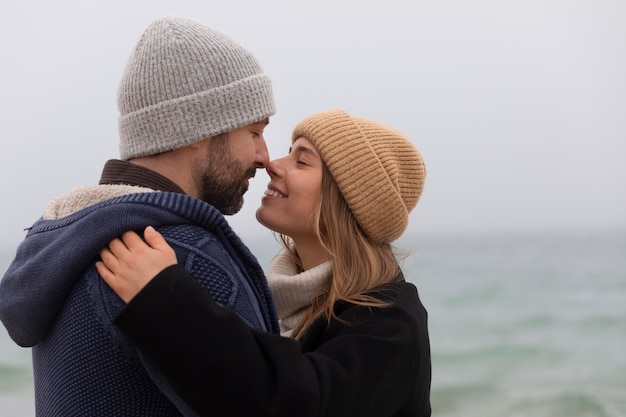 Medium shot couple spending time at seaside