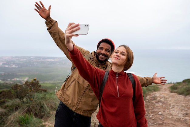 Medium shot couple taking selfie