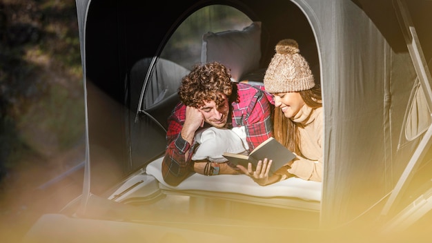 Medium shot cute couple reading together