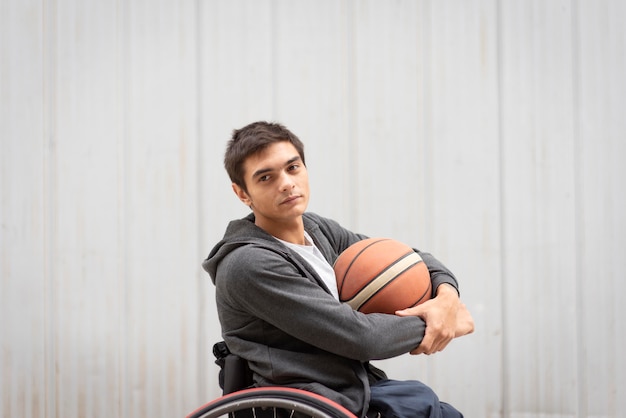 Medium shot disabled man holding ball