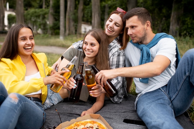 Medium shot friends with pizza