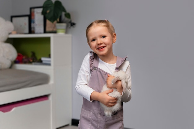 Medium shot girl playing with bunny