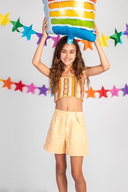 Medium shot girl posing with balloon