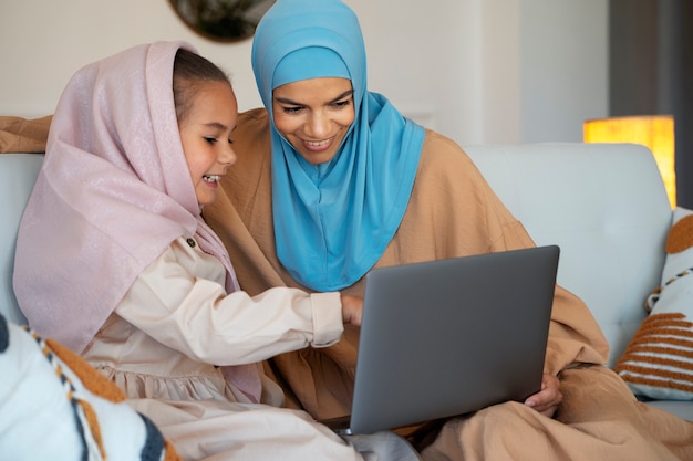 Medium shot girl and woman with laptop