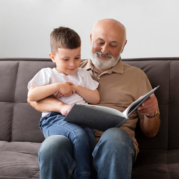 Medium shot grandfather reading to kid