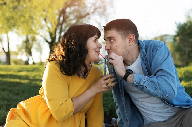 Medium shot happy couple with drink