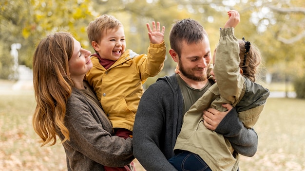 Medium shot happy family outdoors