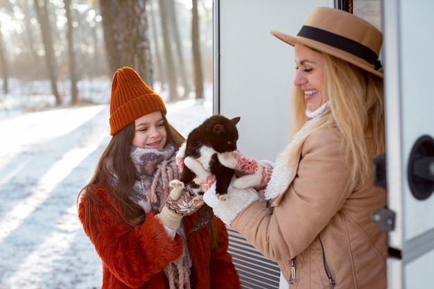 Medium shot happy family with cat