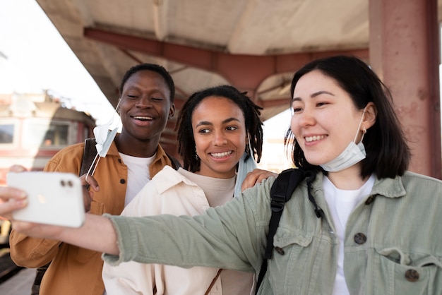 Medium shot happy friends taking selfie