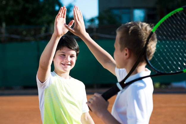 medium shot happy kids high fiving