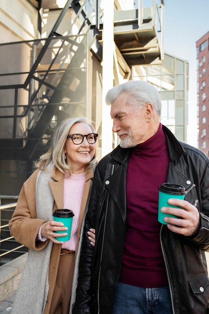 Medium shot happy senior couple with coffee