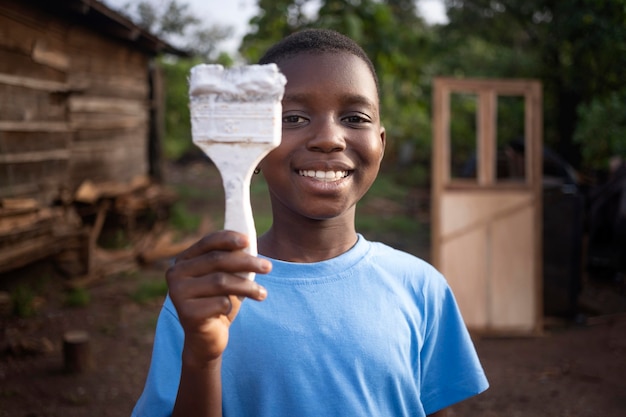 Medium shot kid holding brush