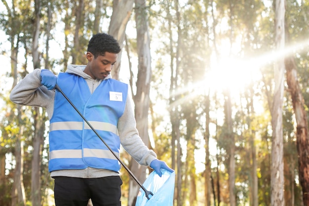 Medium shot man collecting garbage