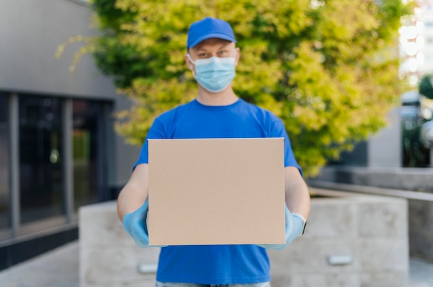 Medium shot man holding box