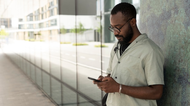 Medium shot man holding phone