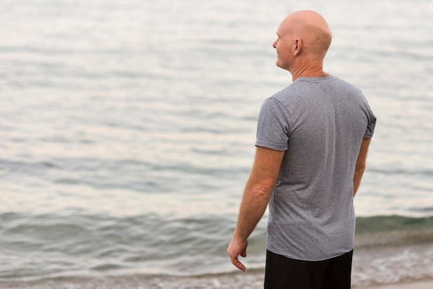 Medium shot man looking at sea