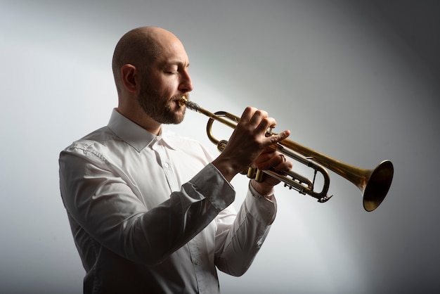 Medium shot man playing trumpet