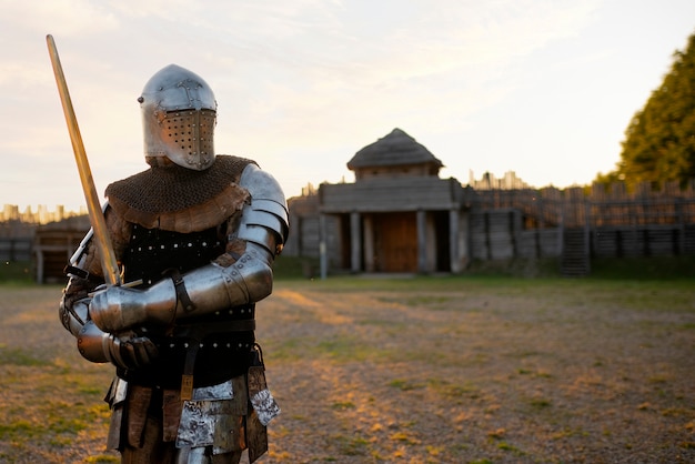 Medium shot man posing as a medieval soldier