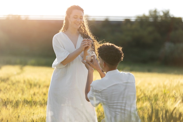 Medium shot man proposing with ring