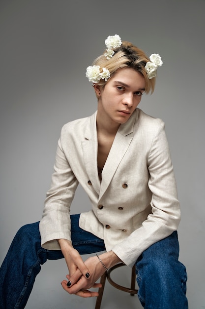 Medium shot man sitting on chair with flowers