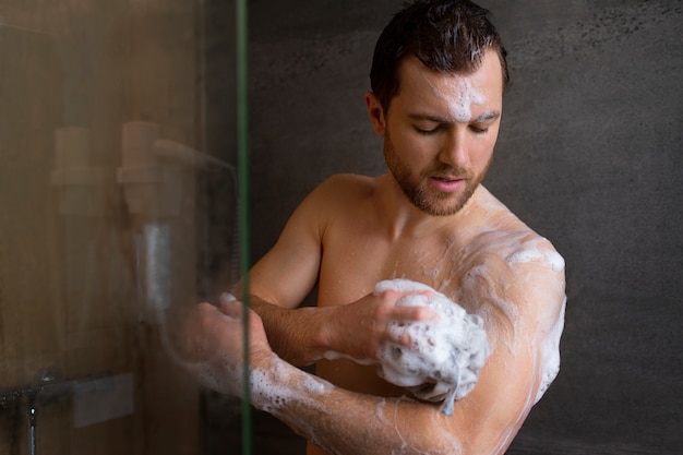 Medium shot man taking shower