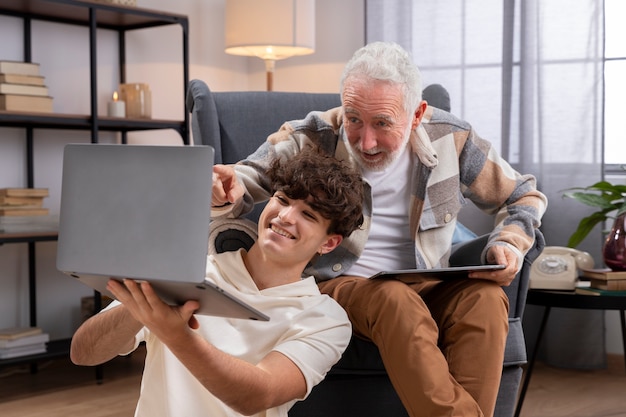 Medium shot man and teen looking at laptop