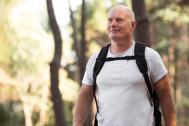 Medium shot man with backpack in nature