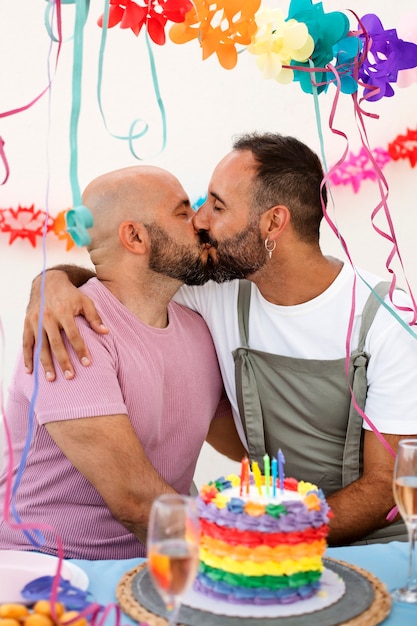 Medium shot men kissing at birthday party