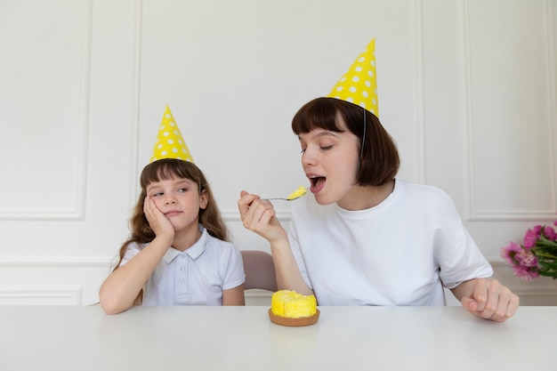 Medium shot mother eating cupcake