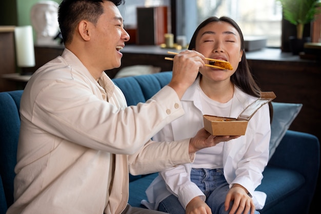 Medium shot people eating asian food