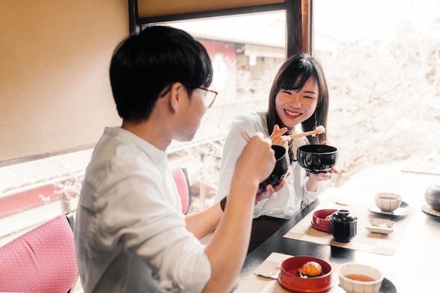 Medium shot people eating delicious food